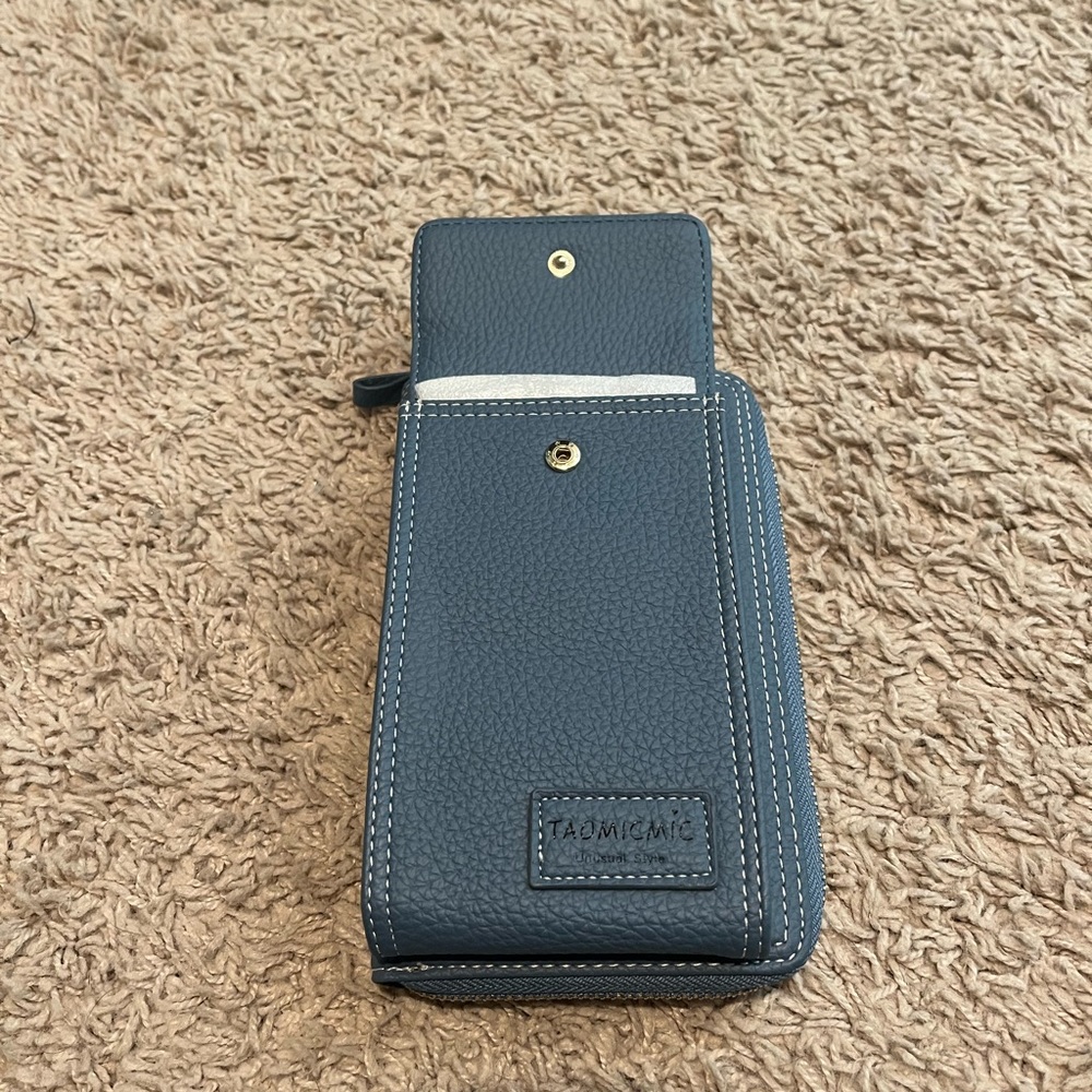 Blue travel crossbody wallet with phone pouch